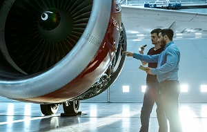 two technicians inspecting a turbofan engine