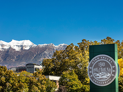 decorative image of UVU university sign in front of campus