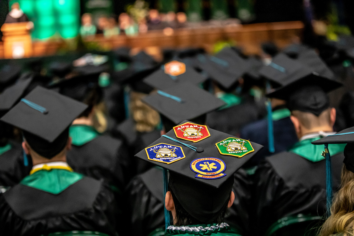 View from behind graduates, showing their decorated caps