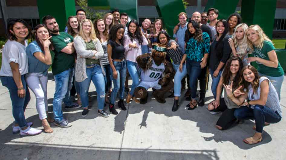 group of students posing in front of UVU picture spot