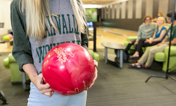 Student wearing UVU gear for Wolverine Wednesday at the bowling alley