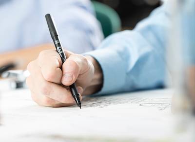 Image of a person writing on a piece of paper
