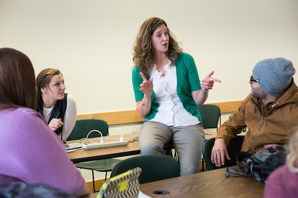 Image of a professor speaking in front of a classroom