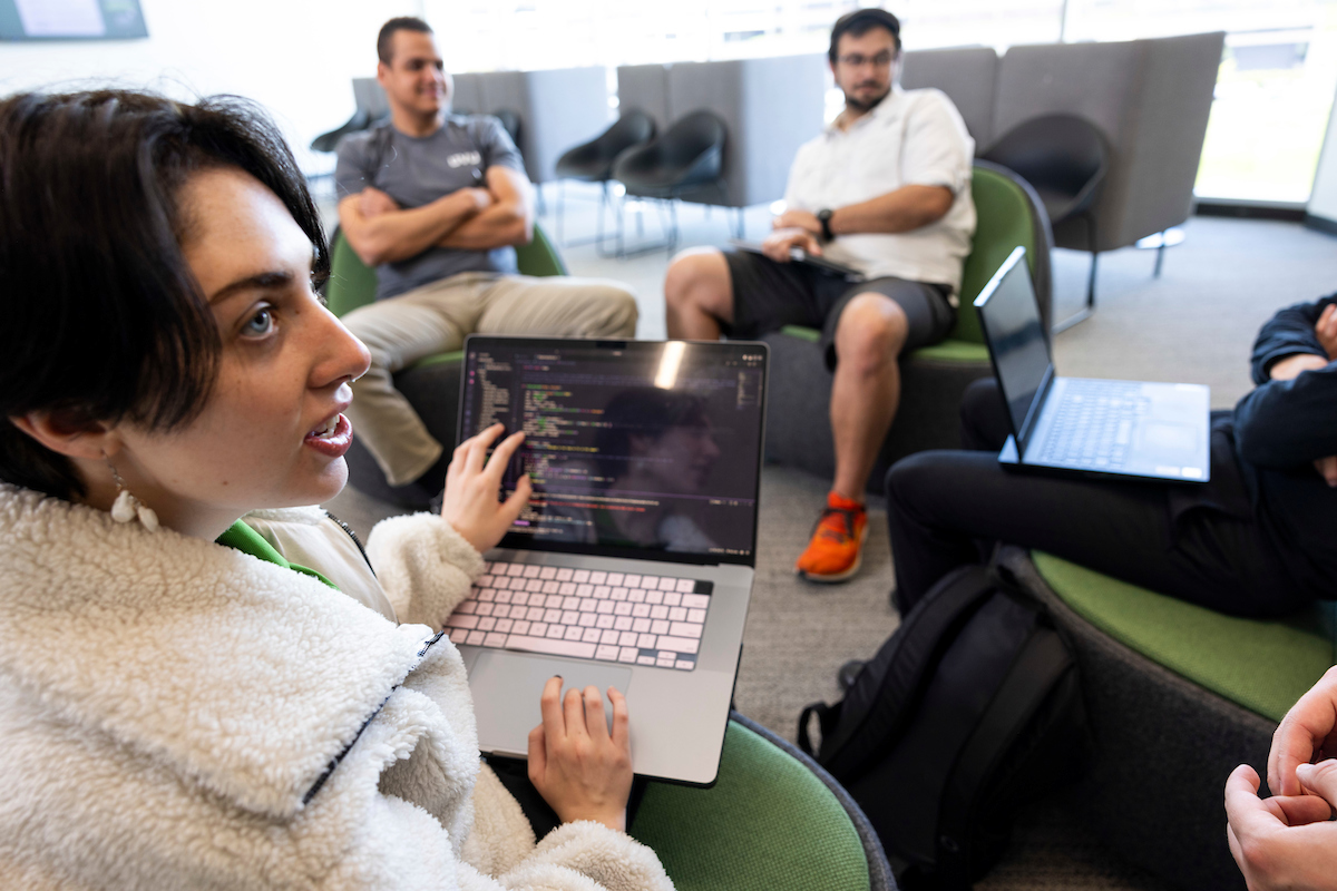 person writing code on a laptop