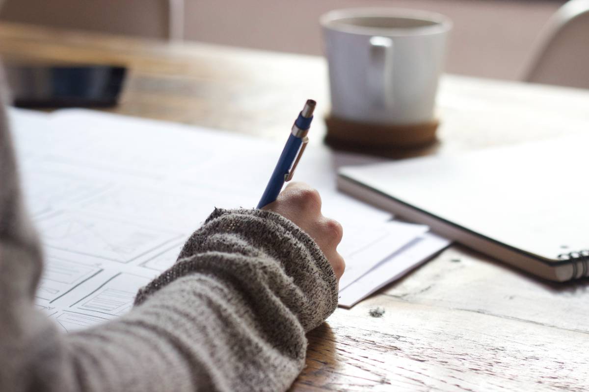 Image of someone writing on a piece of paper