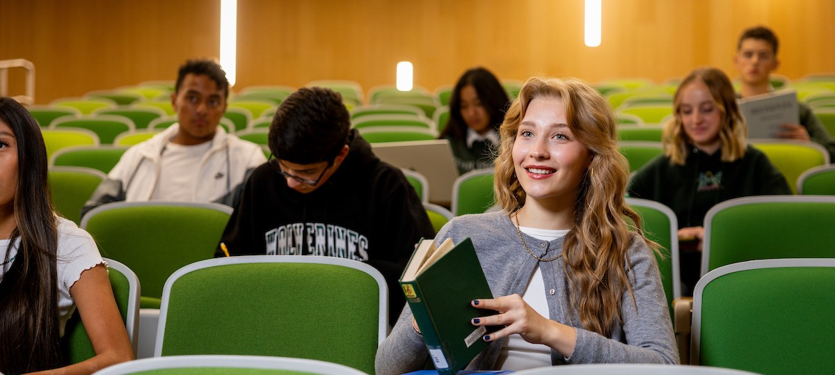 concurrent enrollment student sitting in a university lecture hall