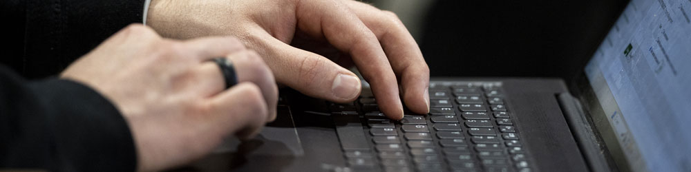 hands on a laptop keyboard