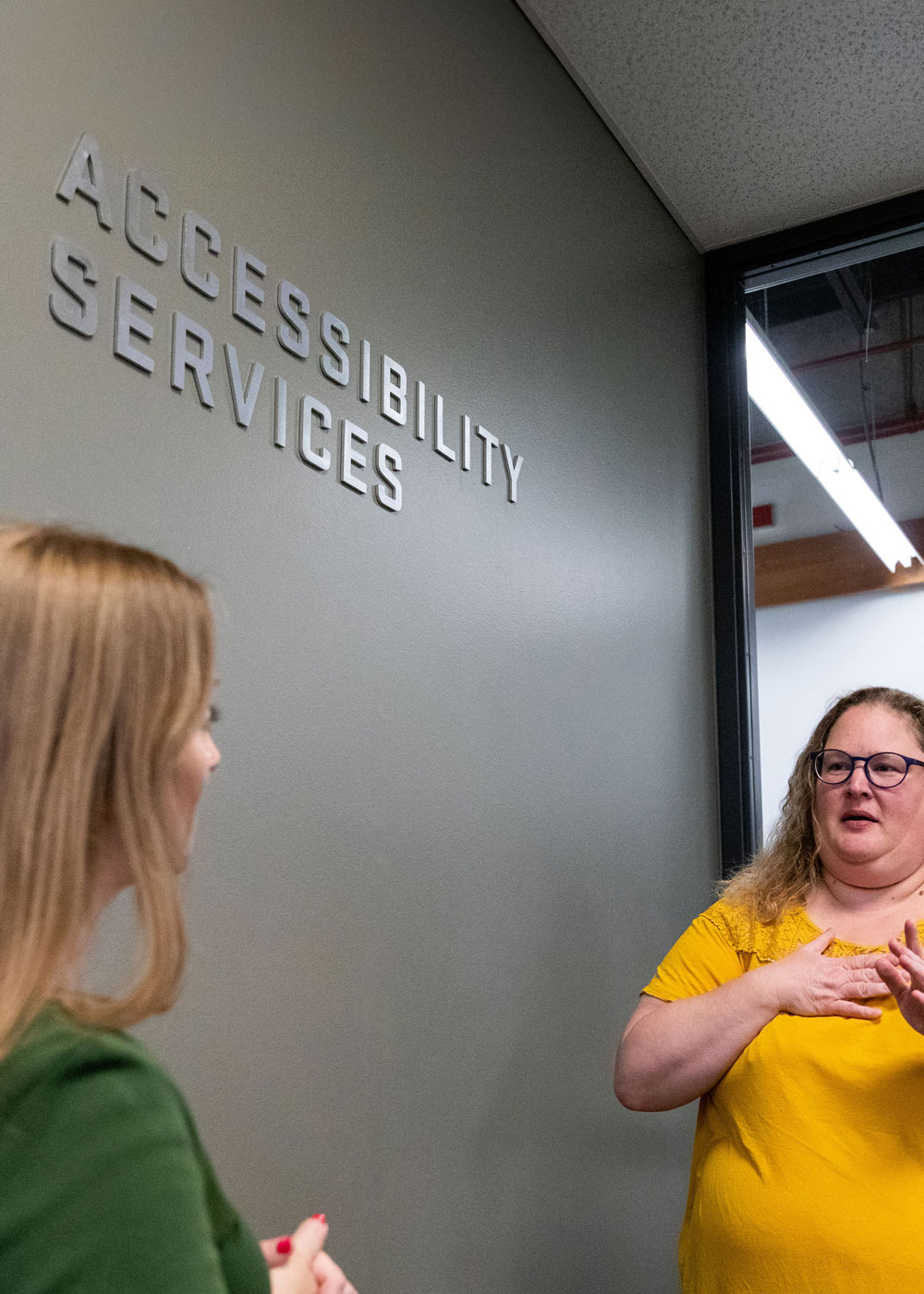 Women talking together outside of Accessibility Services office