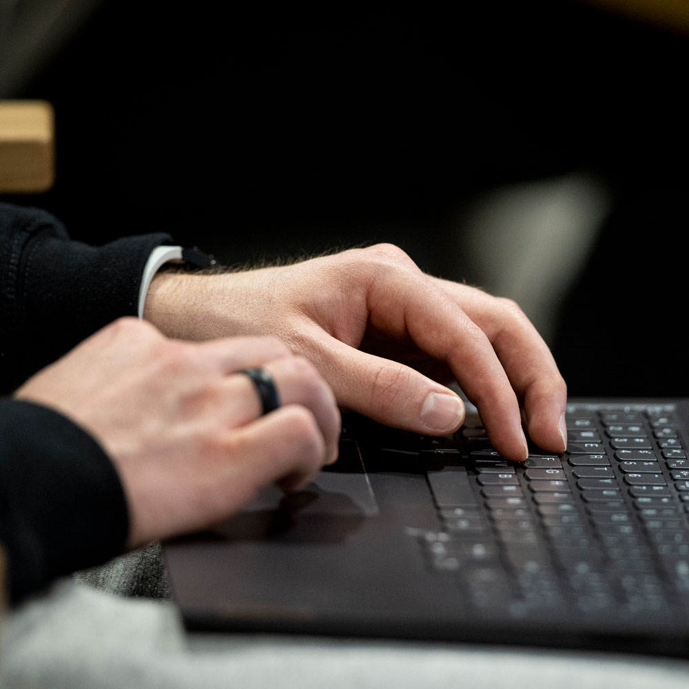 hands on a laptop keyboard