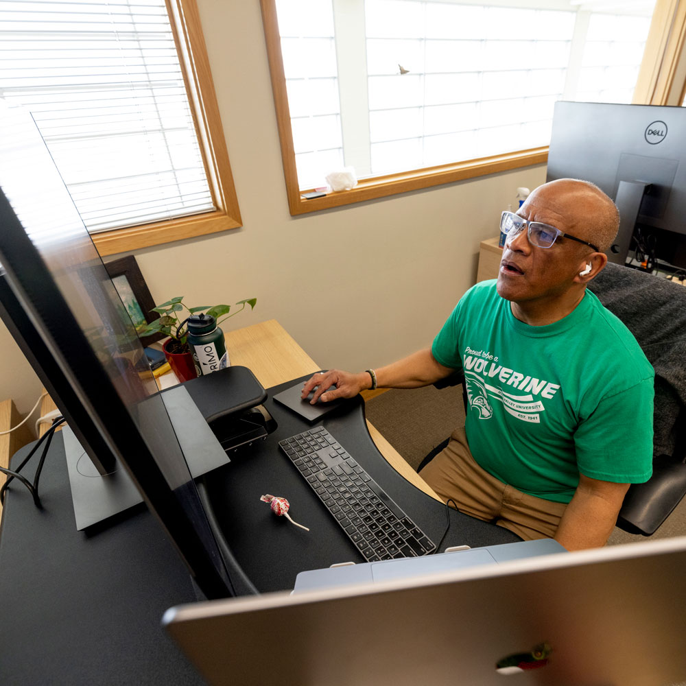 faculty member working at a computer station