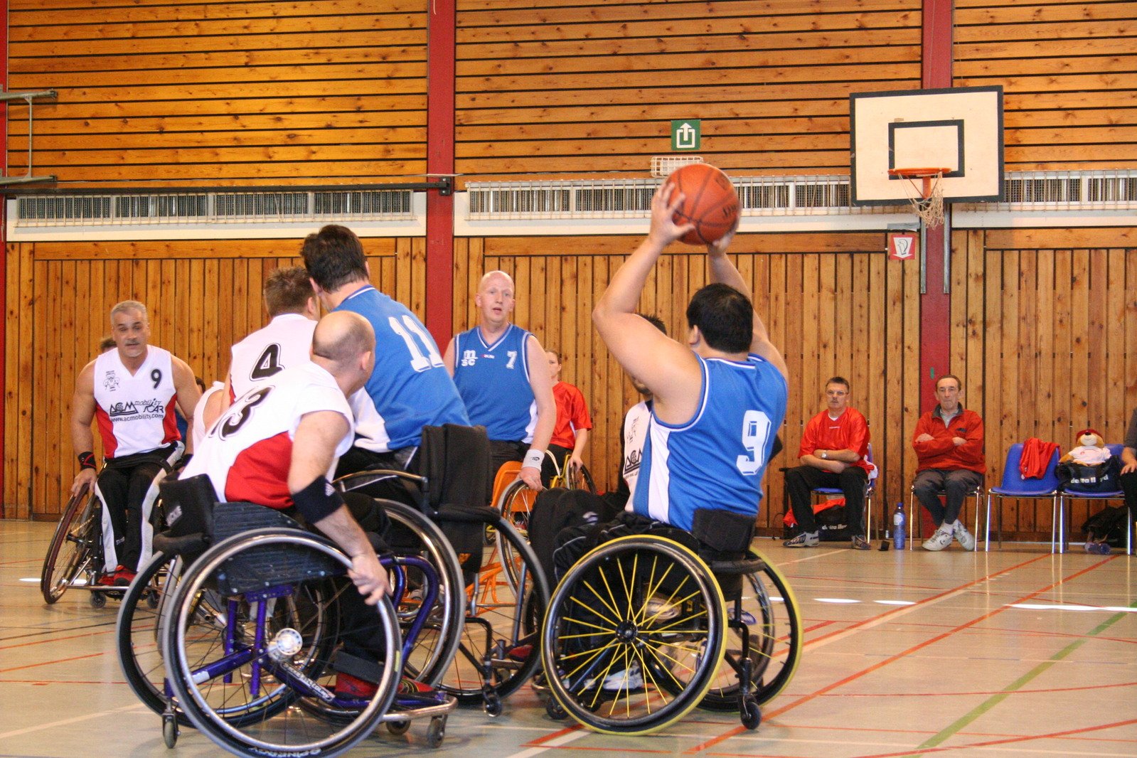 Individuals playing wheelchair basketball