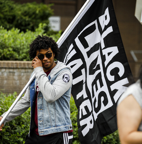 ADI student holding flag