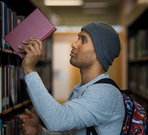 student in library