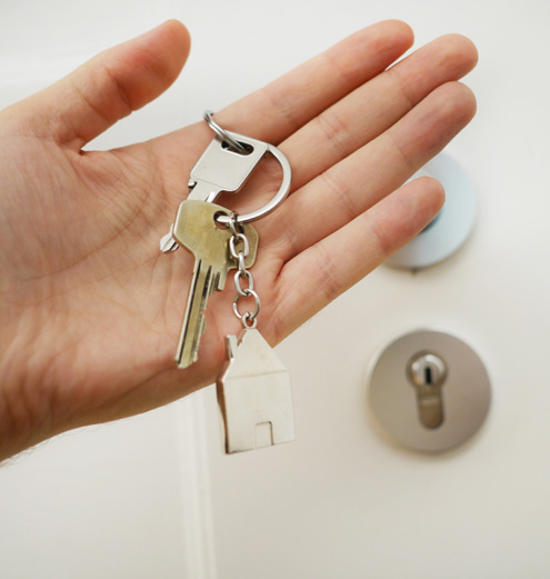keys to a house in hand