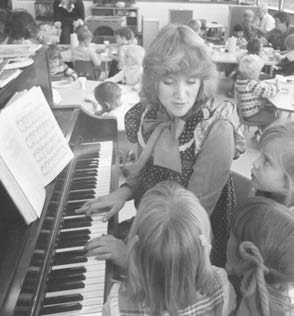 woman teaching child piano