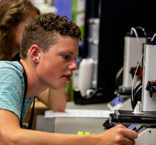 PREP student working with 3D printing machine