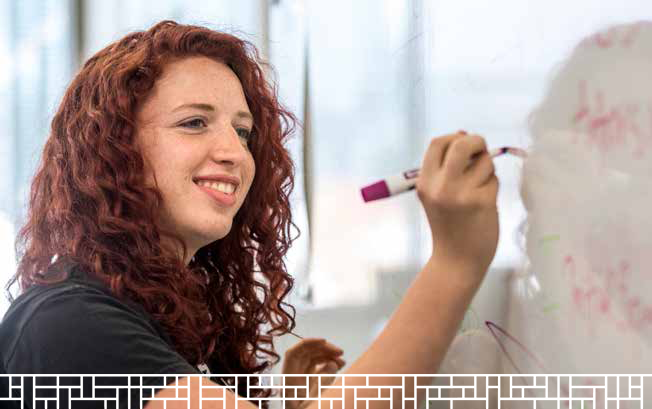 woman studant working on white board