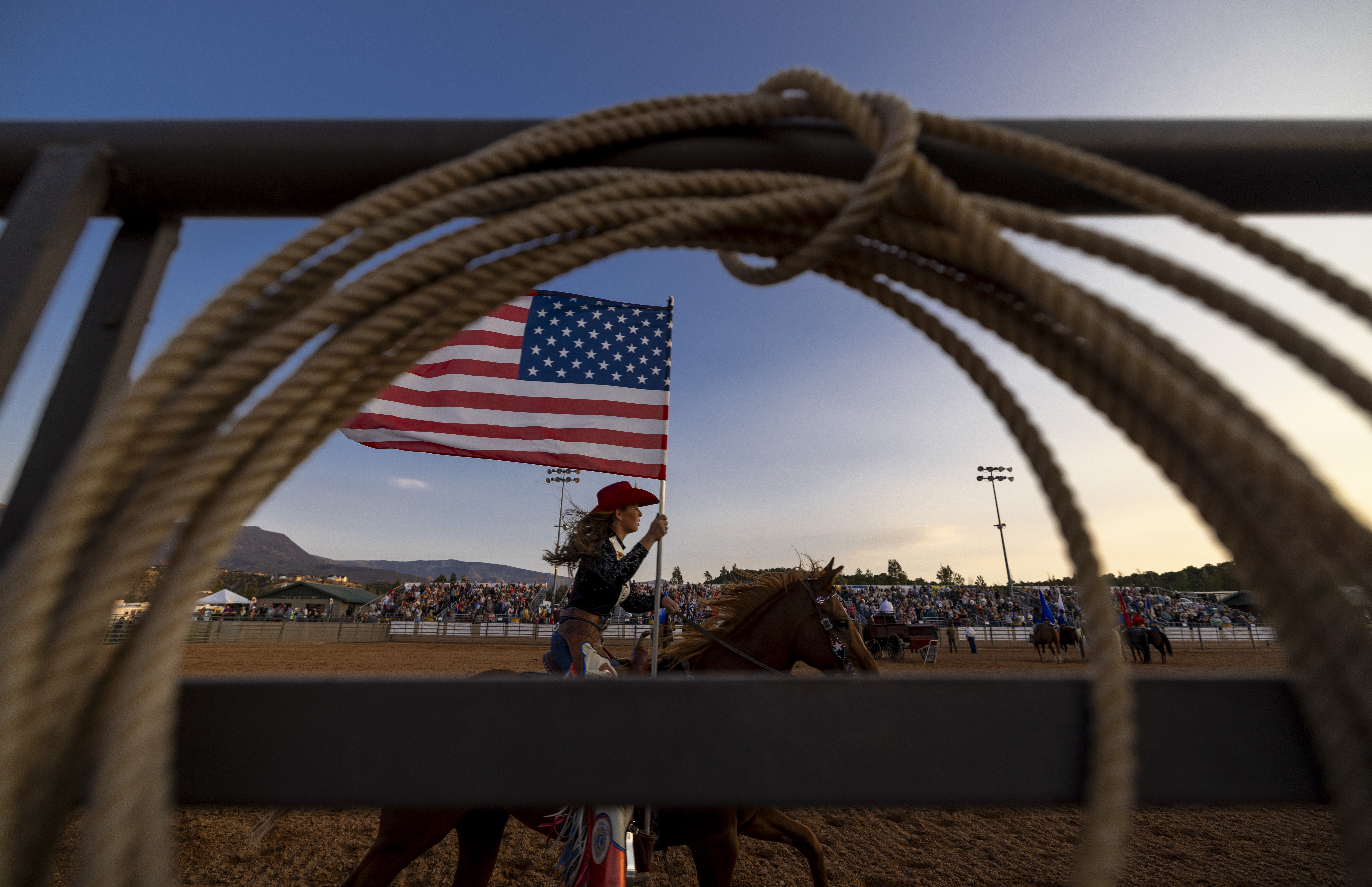cowgirl riding hose with american flag