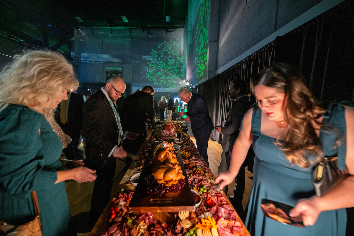 event guests getting food at serving station