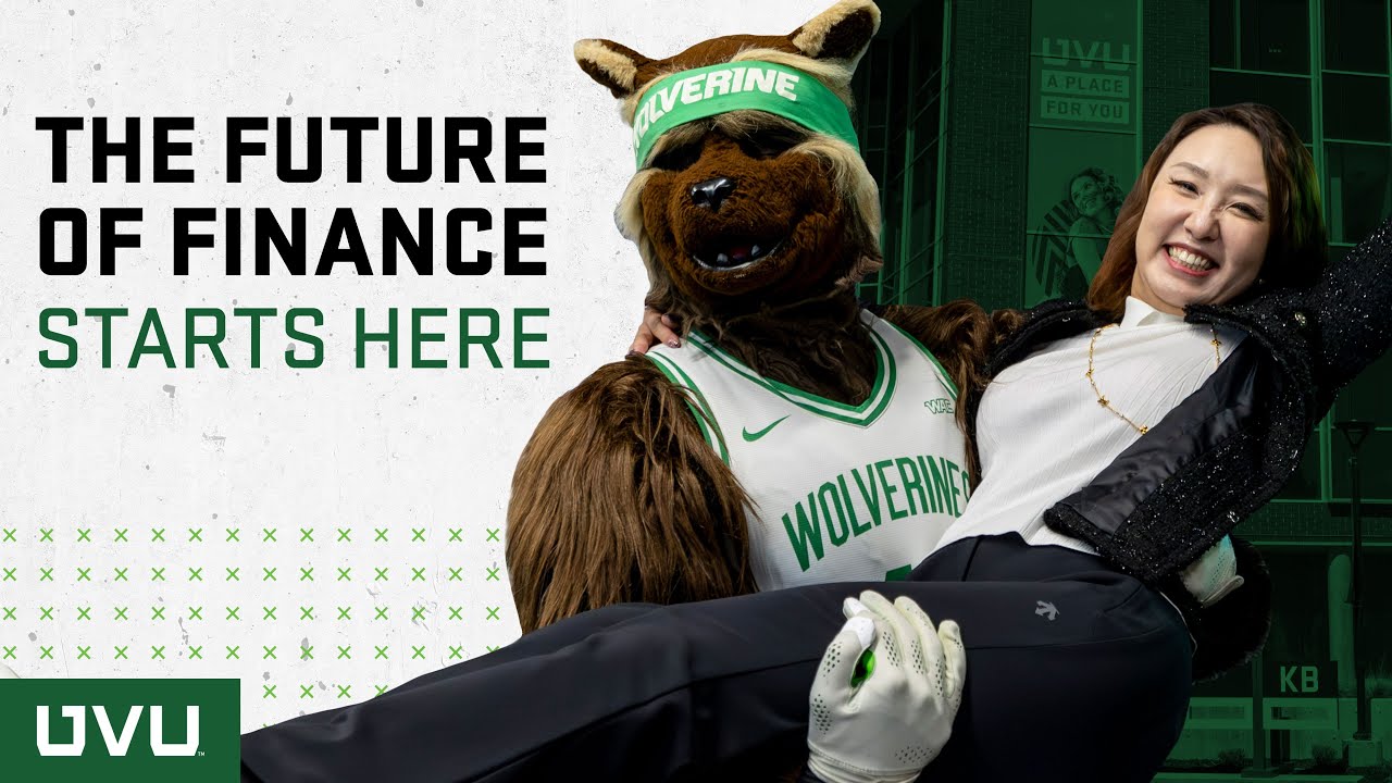 Willie the UVU mascot holding a student up
