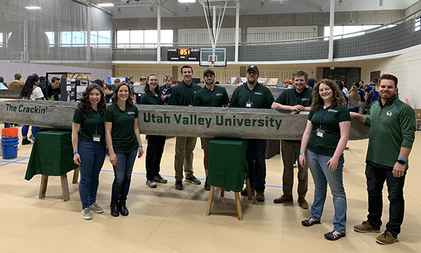 the civil engineering students pose with their concrete canoe, "the crackin'"