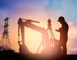 Sun setting on a surveyor at a construction site