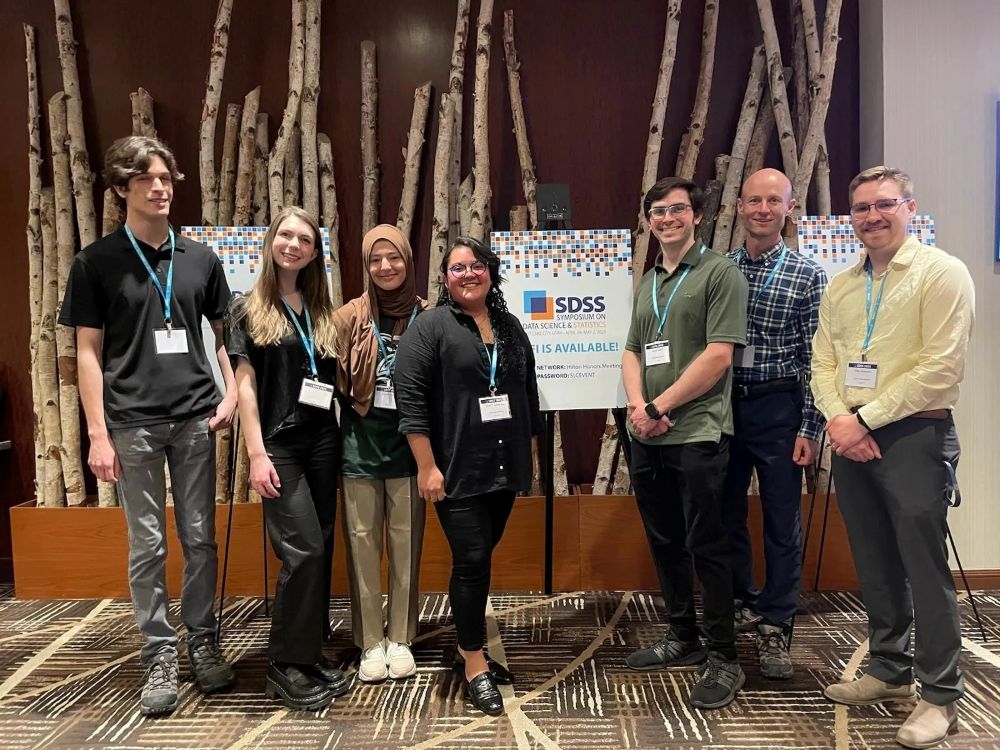 Brian Knaeble posing with students at the Causal Inference Conference