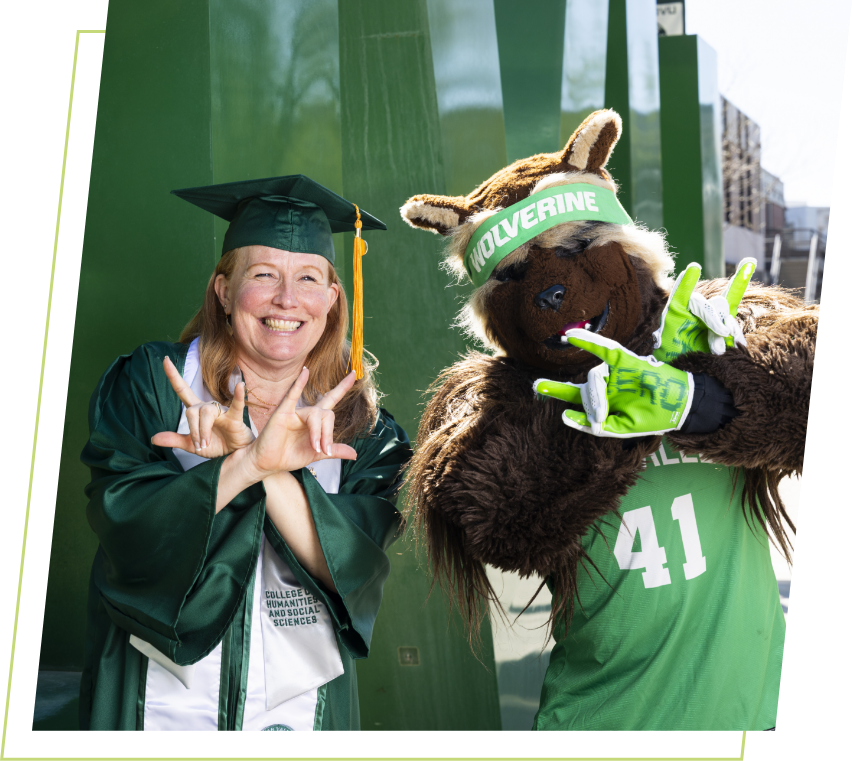grad student with willie the wolverine mascot