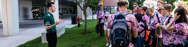 A UVU ambassador leading a campus tour group