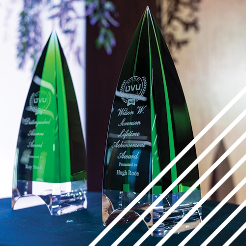 Close-up photo of two green UVU Alumni Award trophies. Close-up photo of two green UVU Alumni Award trophies.