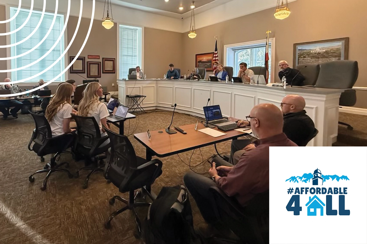 Sitting at a table in a meeting hall, UVU public relations and strategic communications students present to the Heber City Council members, who are seated behind a large podium. Sitting at a table in a meeting hall, UVU public relations and strategic communications students present to the Heber City Council members, who are seated behind a large podium.