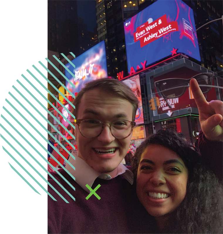 UVU student Evan West and his wife Ashley West smile in front of a billboard displaying their design work in New York City’s Times Square. 