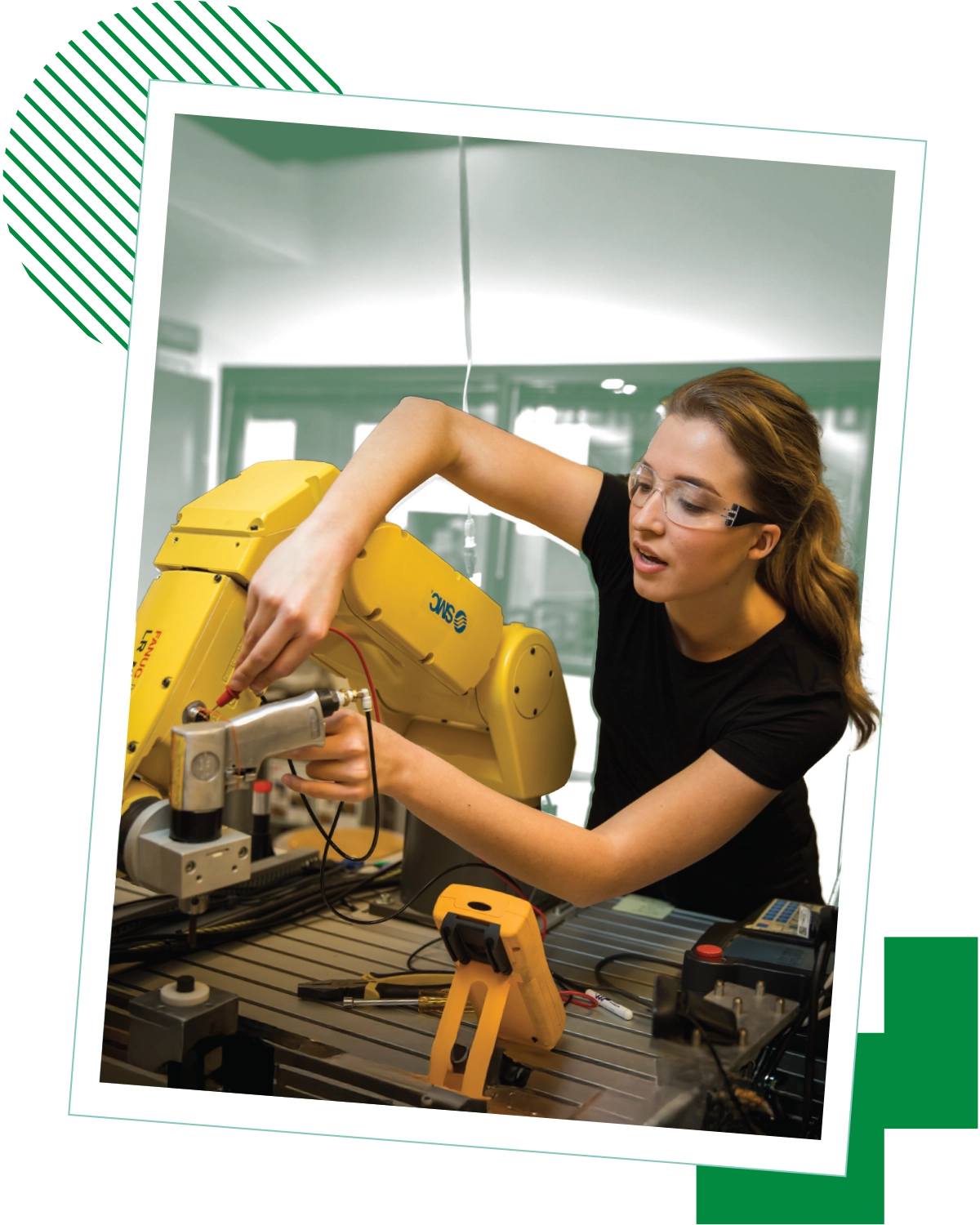 A woman in a black shirt and safety goggles operates machinery in a lab at UVU. A woman in a black shirt and safety goggles operates machinery in a lab at UVU.