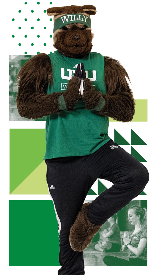 Willy the Wolverine, wearing green UVU attire, does tree pose. Willy the Wolverine, wearing green UVU attire, does tree pose.