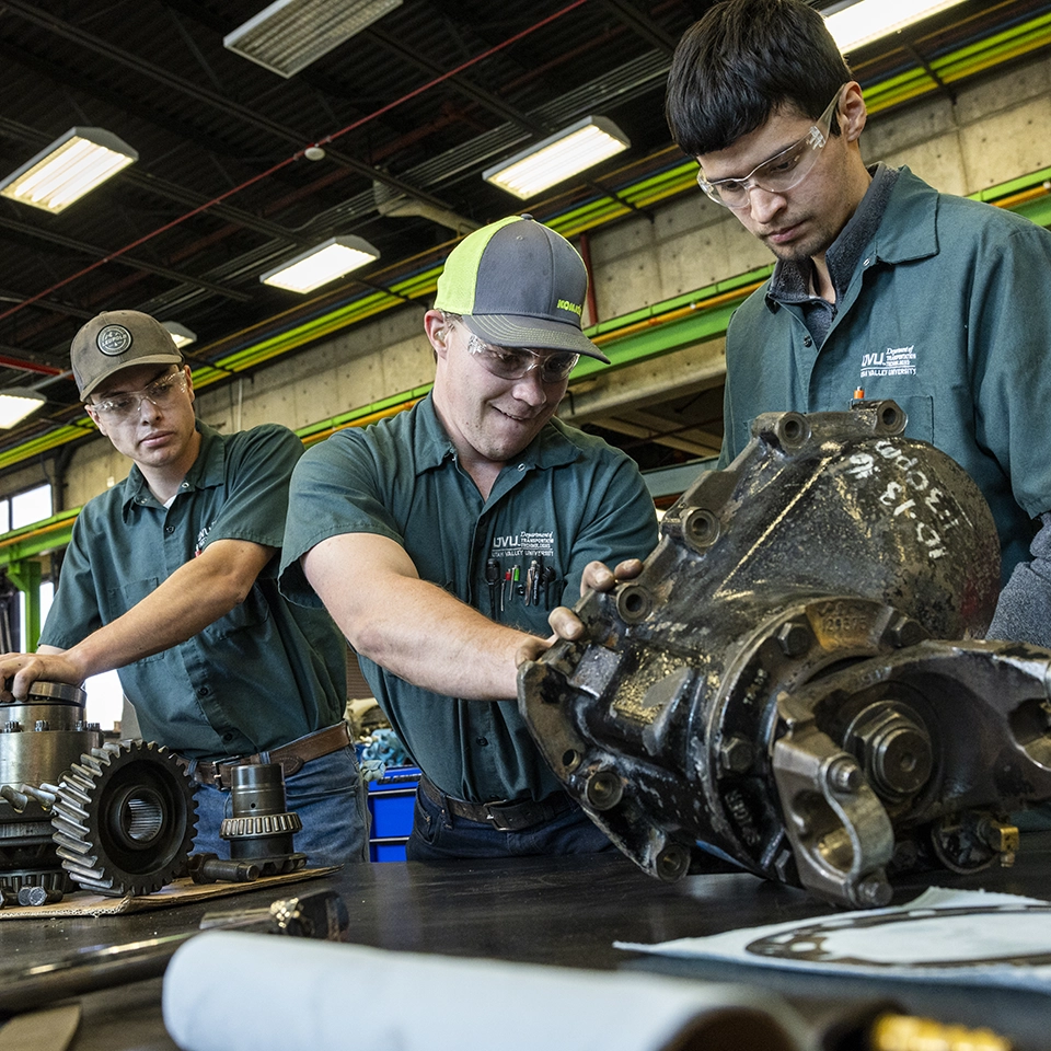 Wearing caps and safety goggles, students in the UVU Department of Transportation Technologies work with machinery. Wearing caps and safety goggles, students in the UVU Department of Transportation Technologies work with machinery.