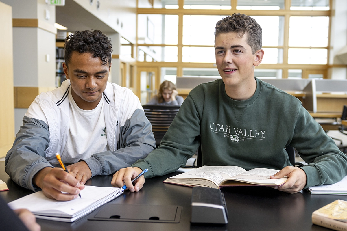Two students study at a table in the Fulton Library. Two students study at a table in the Fulton Library.
