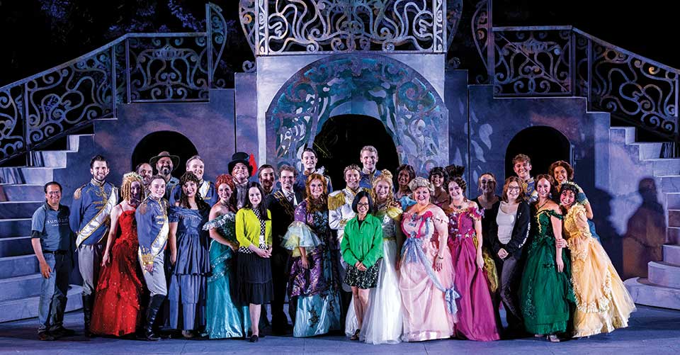 Group photo of the cast of the UVU School of the Arts production of Rodgers and Hammerstein’s “Cinderella” with President Astrid S. Tuminez on stage at the Sundance Mountain Resort outdoor amphitheater. 