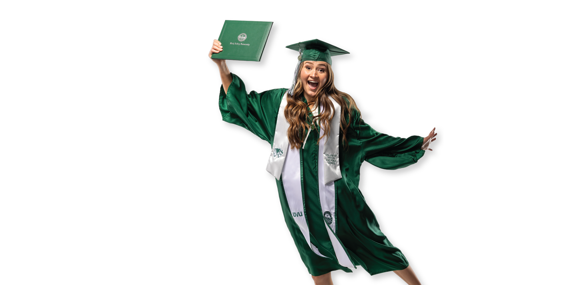 A UVU graduate in graduation regalia victoriously holds up her university degree.