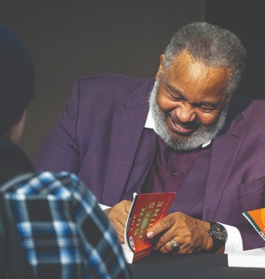 Martin Luther King Jr. Commemoration Week speaker Anthony Ray Hinton signs copies of his book for students in January 2023. 