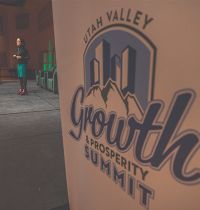 Close shot of a sign reading: Utah Valley Growth and Prosperity Summit. 