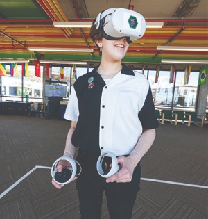 A student on UVU’s Orem Campus wears a virtual reality (VR) headset. 