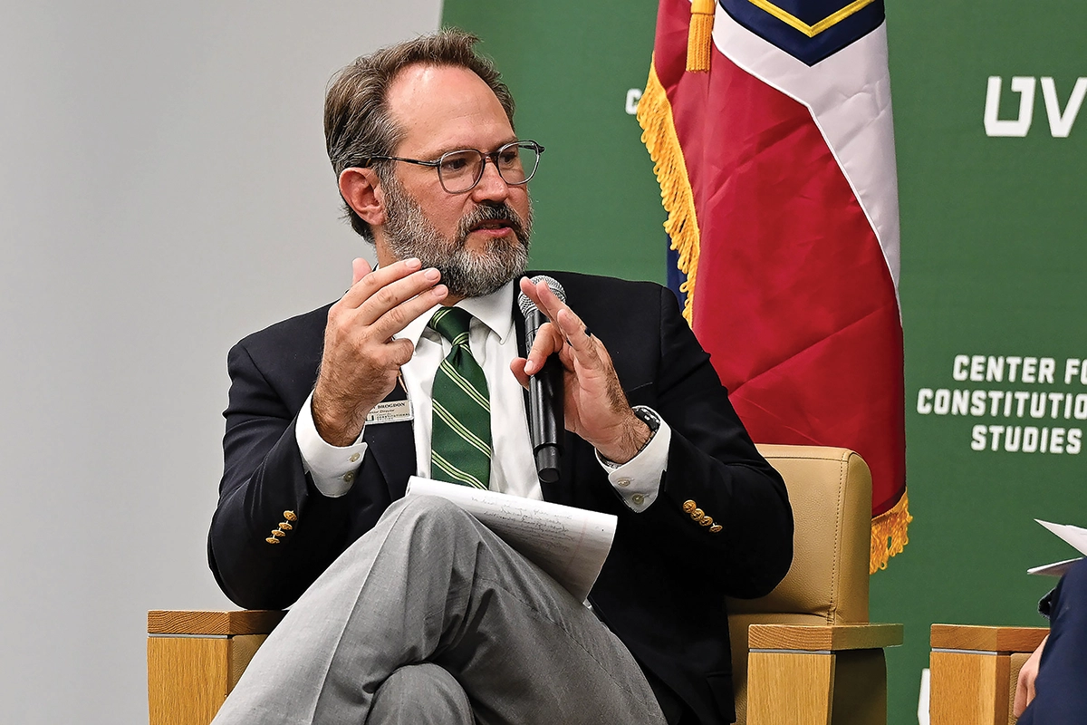 Matthew Brogdon, senior director of UVU’s Center for Constitutional Studies, speaks on stage in front of a Utah flag at the fall 2024 Constitution Day conference. Matthew Brogdon, senior director of UVU’s Center for Constitutional Studies, speaks on stage in front of a Utah flag at the fall 2024 Constitution Day conference.