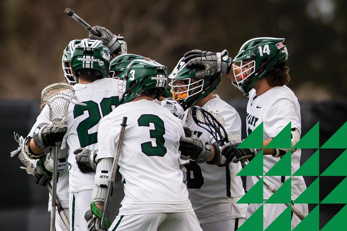 UVU men’s lacrosse players in white jerseys huddle on the field UVU men’s lacrosse players in white jerseys huddle on the field