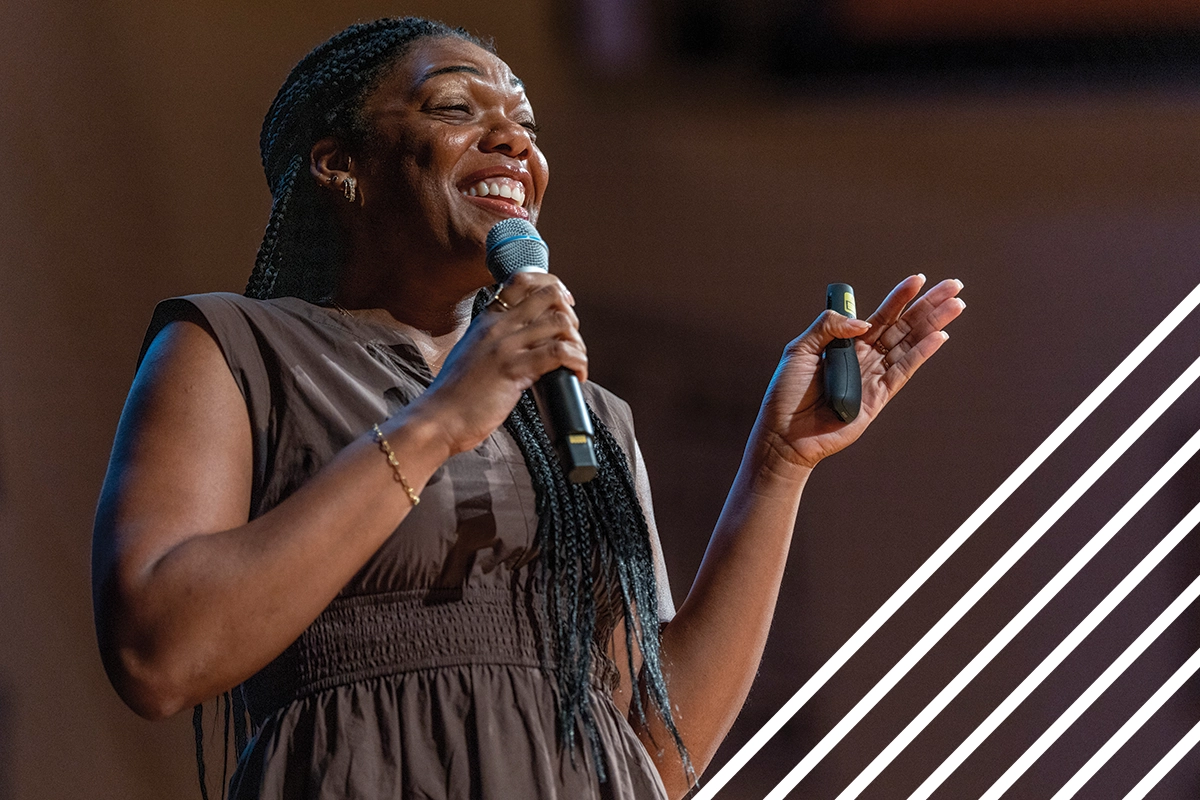 Wearing a brown dress, mental health educator Minaa B. speaks on stage during UVU’s 2024 Conference on Mental Health. Wearing a brown dress, mental health educator Minaa B. speaks on stage during UVU’s 2024 Conference on Mental Health.