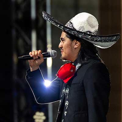 Man sings on stage wearing a traditional Mexico Sombrero and outfit. Man sings on stage wearing a traditional Mexico Sombrero and outfit.