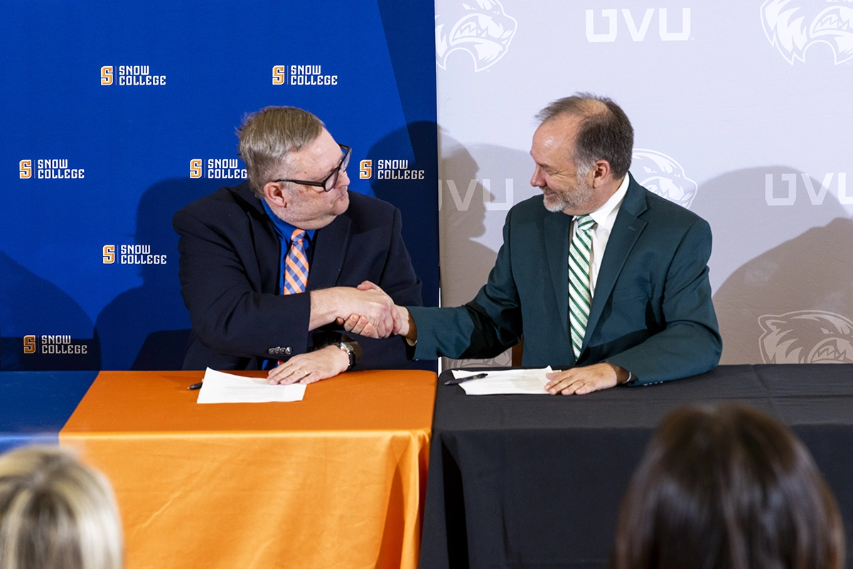 UVU Provost and Senior Vice President F. Wayne Vaught shakes hands with the president of Snow College. 