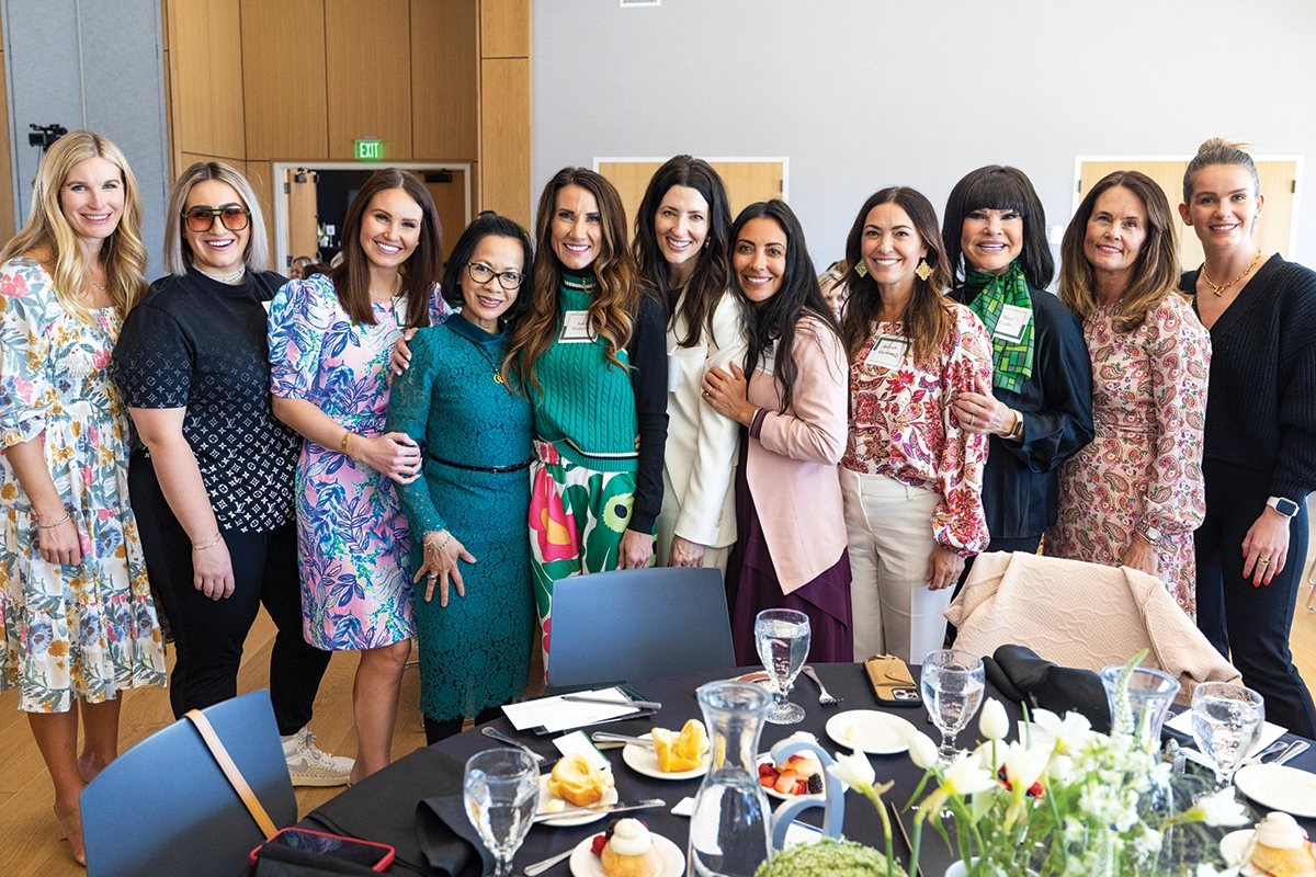 A group of women pose with President Astrid S. Tuminez during the 2024 Women’s Success Center luncheon.