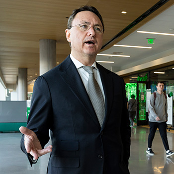 Utah businessman Brandon Fugal, wearing a suit and tie, speaks on UVU campus. 
