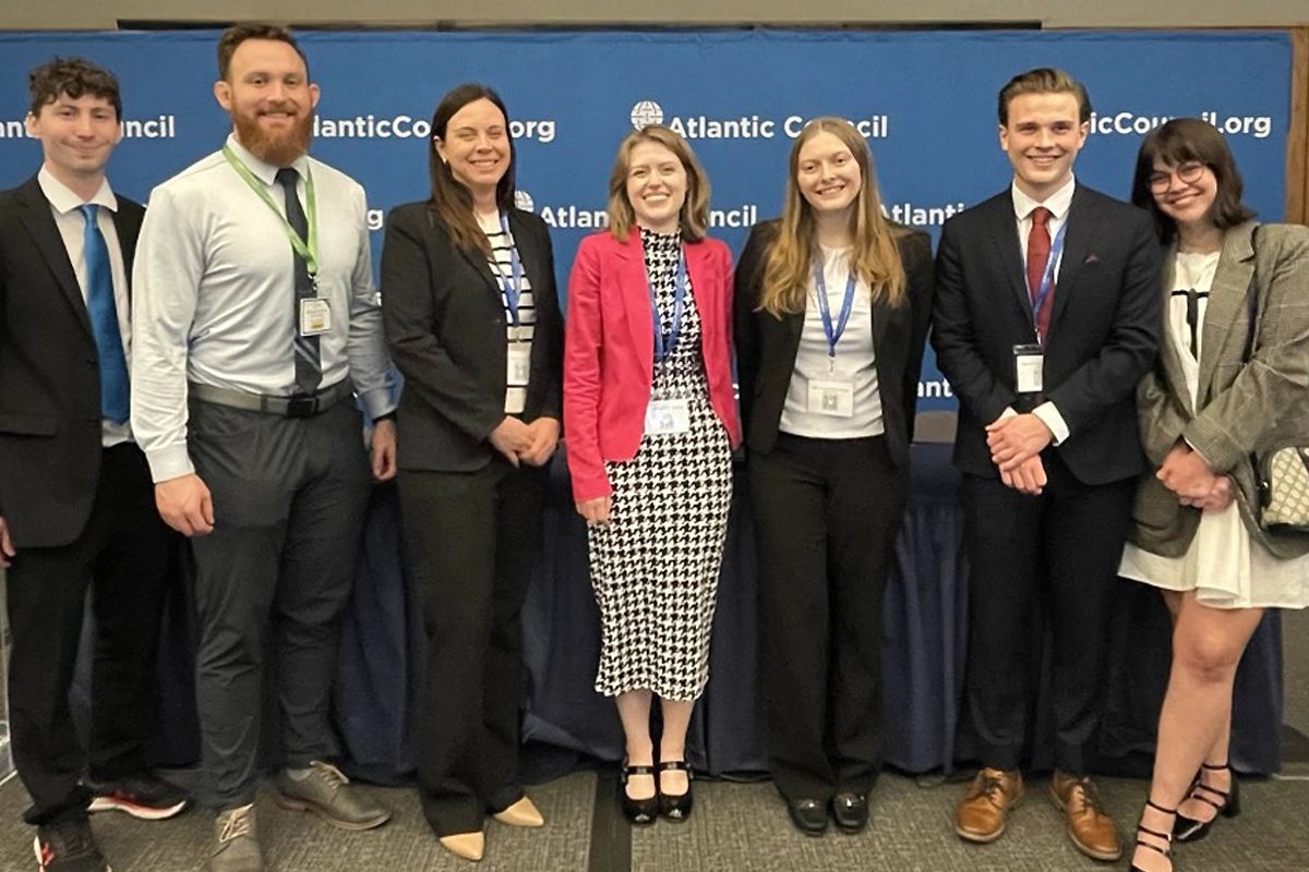 Seven students in nice clothing stand proudly. Seven students in nice clothing stand proudly.