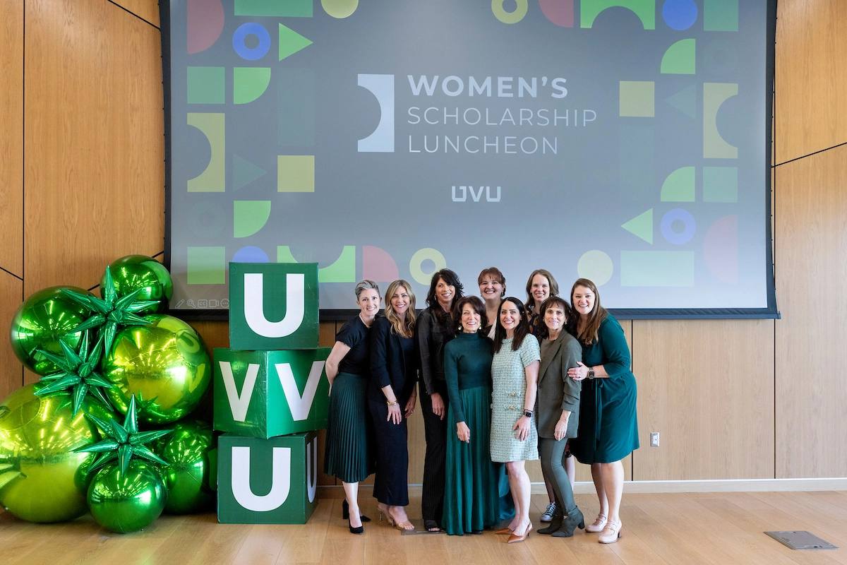 Women at the Scholarship Luncheon pose next to giant letter blocks UVU. Women at the Scholarship Luncheon pose next to giant letter blocks UVU.